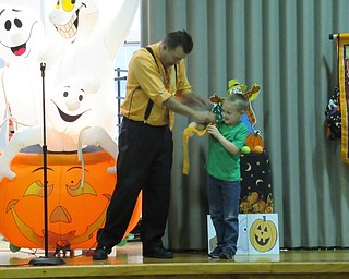 Neighbors | Jessica Harker.Gordon Russ performed a magic trick for Poland Union Elementary School student Camden Hiznay by pulling a hankercheif out of his sleeve Oct. 29.
