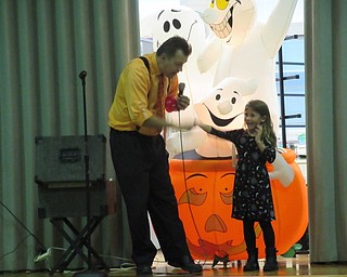 Neighbors | Jessica Harker.Magician Gordon Russ pulled volunteer Brooklyn Simon on to the stage during his Spooky Monster Magic Show performed at Poland Union Elementary School on Oct. 29.