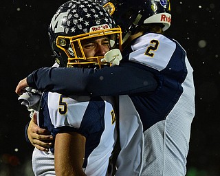 AURORA, OHIO - NOVEMBER 9, 2018: McDonald's Dominic Schadl, left, is embraced by Ryan Scala after McDonald was defeated by Mogadore 28-7, Friday night at Aurora High School. DAVID DERMER | THE VINDICATOR