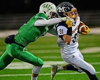 AURORA, OHIO - NOVEMBER 9, 2018: McDonald's Alex Cintron is tackled by Mogadore's Eli Robertson during the first half of their game, Friday night at Aurora High School. Mogadore won 28-7. DAVID DERMER | THE VINDICATOR