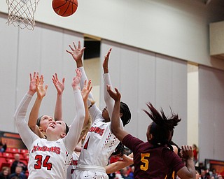 YSU and Loyola reach up for the ball as YSU tries to make a basket during the first half of their game at YSU on Friday night. EMILY MATTHEWS | THE VINDICATOR