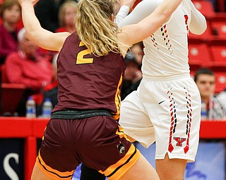 YSU's Alison Smolinski looks to pass the ball around Loyola's Ellie Rice during the first half of their game at YSU on Friday night. EMILY MATTHEWS | THE VINDICATOR