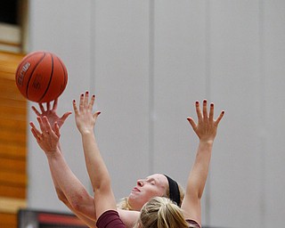 YSU's Sarah Cash tries to shoot as Loyola's Allison Day tries to block her during the first half of their game at YSU on Friday night. EMILY MATTHEWS | THE VINDICATOR