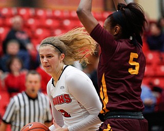 YSU's Chelsea Olson tries to get the ball past Loyola's Tiara Wallace during the first half of their game at YSU on Friday night. EMILY MATTHEWS | THE VINDICATOR