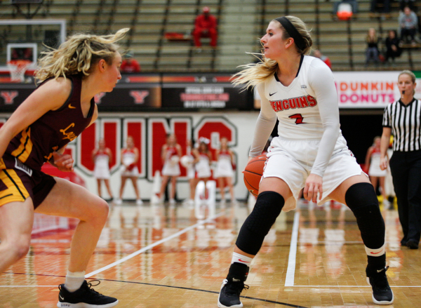 YSU's Alison Smolinski looks to pass while Loyola's Ellie Rice watches the ball during the first half of their game at YSU on Friday night. EMILY MATTHEWS | THE VINDICATOR