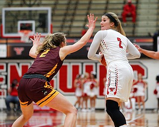 YSU's Alison Smolinski looks to pass the ball while Loyola's Ellie Rice tries to block during the first half of their game at YSU on Friday night. EMILY MATTHEWS | THE VINDICATOR