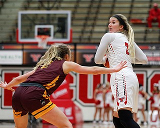 YSU's Alison Smolinski looks to pass the ball while Loyola's Ellie Rice tries to block during the first half of their game at YSU on Friday night. EMILY MATTHEWS | THE VINDICATOR