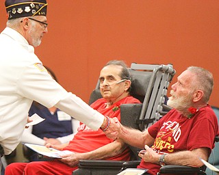 William D. Lewis The Vindicator   Tom Churilla, left, a member of DAV Chptr 2 shakes hands with veteran Dennis Bell, a resident of Heritage Manor during a Veterans Day event Heritage Manor11-9-18. In background is veteran Sam Mosca, also a Heritage Manor Resident