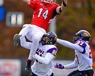 YOUNGSTOWN, OHIO - NOVEMBER 11, 2018: Youngstown State's Zack Torbert falls to the turf while being hit by Northern Iowa's Christian Jegen and Austin Evan during the first half of their game, Saturday afternoon at Stambaugh Stadium. DAVID DERMER | THE VINDICATOR