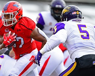 YOUNGSTOWN, OHIO - NOVEMBER 11, 2018: Youngstown State's Tevin McCaster runs away from Northern Iowa's Korby Sander during the first half of their game, Saturday afternoon at Stambaugh Stadium. DAVID DERMER | THE VINDICATOR