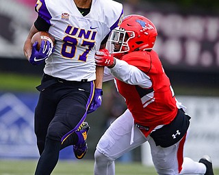 YOUNGSTOWN, OHIO - NOVEMBER 11, 2018: Northern Iowa's Jalen Rima is pulled down by Youngstown State's Cash Mitchell during the first half of their game, Saturday afternoon at Stambaugh Stadium. DAVID DERMER | THE VINDICATOR