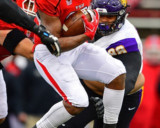 YOUNGSTOWN, OHIO - NOVEMBER 11, 2018: Youngstown State's Tevin McCaster runs away from Northern Iowa's Caden Hougthtelling during the first half of their game, Saturday afternoon at Stambaugh Stadium. DAVID DERMER | THE VINDICATOR