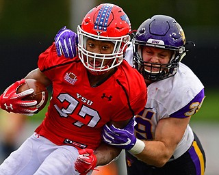 YOUNGSTOWN, OHIO - NOVEMBER 11, 2018: Youngstown State's Tevin McCaster is tackled by Northern Iowa's Duncan Ferch during the second half of their game, Saturday afternoon at Stambaugh Stadium. DAVID DERMER | THE VINDICATOR