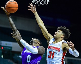 CLEVELAND, OHIO - NOVEMBER 11, 2018: Akron's Jimond Ivey goes to the basket against Youngstown State's Michael Akuchie during the second half of their game, Saturday afternoon at Cleveland State University. DAVID DERMER | THE VINDICATOR