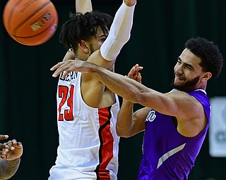 CLEVELAND, OHIO - NOVEMBER 11, 2018: Akron's Tyler Cheese passes around Youngstown State's Olamide Pedersen during the second half of their game, Saturday afternoon at Cleveland State University. DAVID DERMER | THE VINDICATOR