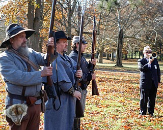 John P. "JP" Brown III, far right, of Boardman, plays taps while, from left, Kellie Wright, of Leetonia, Robert Lintz, of Niles, and Dallas Wright, of Leetonia, salute during the Forgotten Heroes program in Forest Lawn Cemetery in Boardman on Sunday. EMILY MATTHEWS | THE VINDICATOR
