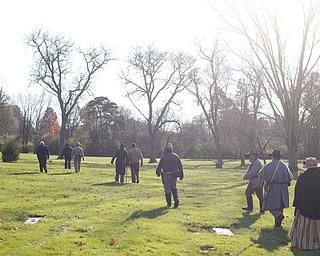 Attendees of the Forgotten Heroes program walk through Forest Lawn Cemetery in Boardman in between stopping at graves to honor veterans on Sunday. EMILY MATTHEWS | THE VINDICATOR