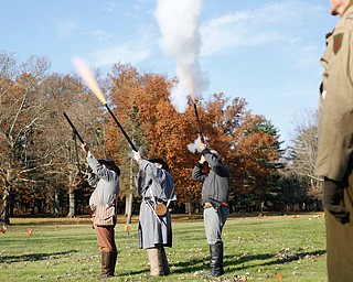 From left, Kellie Wright, of Leetonia, Robert Lintz, of Niles, and Dallas Wright, of Leetonia, fire guns to salute veterans during the Forgotten Heroes program in Forest Lawn Cemetery in Boardman on Sunday. EMILY MATTHEWS | THE VINDICATOR