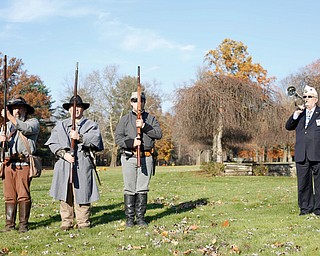 John P. "JP" Brown III, far right, of Boardman, plays taps while, from left, Kellie Wright, of Leetonia, Robert Lintz, of Niles, and Dallas Wright, of Leetonia, stand after saluting veterans during the Forgotten Heroes program in Forest Lawn Cemetery in Boardman on Sunday. EMILY MATTHEWS | THE VINDICATOR