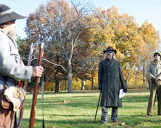 Ron Johnson, center, of Boardman, speaks about local veterans at their grave sites during the Forgotten Heroes program in Forest Lawn Cemetery in Boardman on Sunday. EMILY MATTHEWS | THE VINDICATOR
