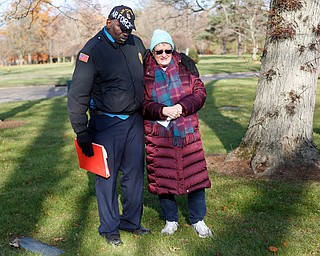 Steffon Jones, left, of Youngstown, and Suzanne Zadell, of Vermilion, stand at the grave of Zadell's father, Raymond Eckert, who had been a sergeant with the 82nd Airborne Medical Division and died after his glider crashed on D-Day, during the Forgotten Heroes program in Forest Lawn Cemetery in Boardman on Sunday. EMILY MATTHEWS | THE VINDICATOR
