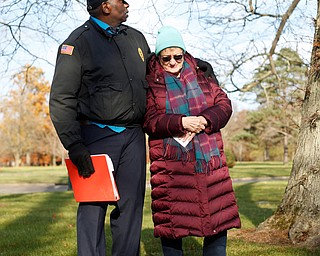 Steffon Jones, left, of Youngstown, and Suzanne Zadell, of Vermilion, stand at the grave of Zadell's father, Raymond Eckert, who had been a sergeant with the 82nd Airborne Medical Division and died after his glider crashed on D-Day, during the Forgotten Heroes program in Forest Lawn Cemetery in Boardman on Sunday. EMILY MATTHEWS | THE VINDICATOR
