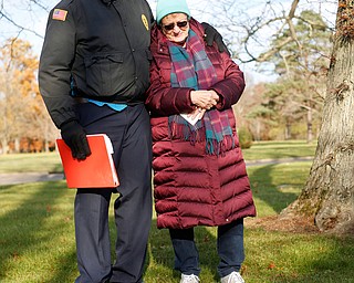 Steffon Jones, left, of Youngstown, and Suzanne Zadell, of Vermilion, stand at the grave of Zadell's father, Raymond Eckert, who had been a sergeant with the 82nd Airborne Medical Division and died after his glider crashed on D-Day, during the Forgotten Heroes program in Forest Lawn Cemetery in Boardman on Sunday. EMILY MATTHEWS | THE VINDICATOR