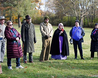 Suzanne Zadell, left, of Vermilion, stands with others near the grave of her father, Raymond Eckert, who had been a sergeant with the 82nd Airborne Medical Division and died after his glider crashed on D-Day, during the Forgotten Heroes program in Forest Lawn Cemetery in Boardman on Sunday. EMILY MATTHEWS | THE VINDICATOR