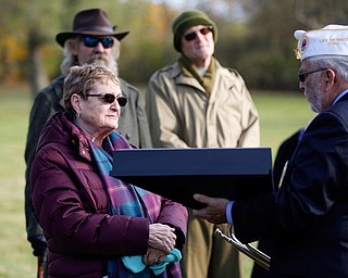 Suzanne Zadell, of Vermilion, is presented with an American flag in honor of all she has done to learn more about her father, Raymond Eckert, who had been a sergeant with the 82nd Airborne Medical Division and died after his glider crashed on D-Day, during the Forgotten Heroes program in Forest Lawn Cemetery in Boardman on Sunday. EMILY MATTHEWS | THE VINDICATOR