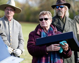 Suzanne Zadell, of Vermilion, is presented with an American flag in honor of all she has done to learn more about her father, Raymond Eckert, who had been a sergeant with the 82nd Airborne Medical Division and died after his glider crashed on D-Day, during the Forgotten Heroes program in Forest Lawn Cemetery in Boardman on Sunday. EMILY MATTHEWS | THE VINDICATOR