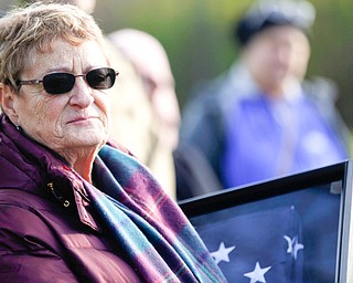 Suzanne Zadell, of Vermilion, is presented with an American flag in honor of all she has done to learn more about her father, Raymond Eckert, who had been a sergeant with the 82nd Airborne Medical Division and died after his glider crashed on D-Day, during the Forgotten Heroes program in Forest Lawn Cemetery in Boardman on Sunday. EMILY MATTHEWS | THE VINDICATOR