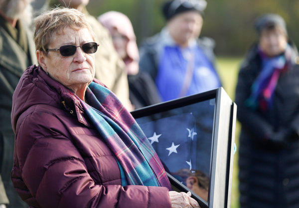 Suzanne Zadell, of Vermilion, is presented with an American flag in honor of all she has done to learn more about her father, Raymond Eckert, who had been a sergeant with the 82nd Airborne Medical Division and died after his glider crashed on D-Day, during the Forgotten Heroes program in Forest Lawn Cemetery in Boardman on Sunday. EMILY MATTHEWS | THE VINDICATOR