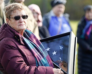 Suzanne Zadell, of Vermilion, is presented with an American flag in honor of all she has done to learn more about her father, Raymond Eckert, who had been a sergeant with the 82nd Airborne Medical Division and died after his glider crashed on D-Day, during the Forgotten Heroes program in Forest Lawn Cemetery in Boardman on Sunday. EMILY MATTHEWS | THE VINDICATOR