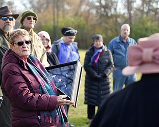 Suzanne Zadell, of Vermilion, is presented with an American flag in honor of all she has done to learn more about her father, Raymond Eckert, who had been a sergeant with the 82nd Airborne Medical Division and died after his glider crashed on D-Day, during the Forgotten Heroes program in Forest Lawn Cemetery in Boardman on Sunday. EMILY MATTHEWS | THE VINDICATOR