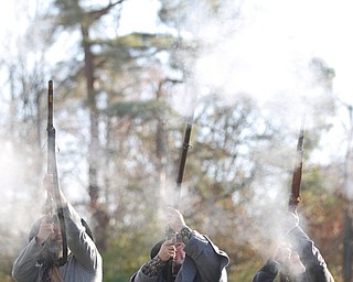 From left, Kellie Wright, of Leetonia, Robert Lintz, of Niles, and Dallas Wright, of Leetonia, fire guns to salute veterans during the Forgotten Heroes program in Forest Lawn Cemetery in Boardman on Sunday. EMILY MATTHEWS | THE VINDICATOR