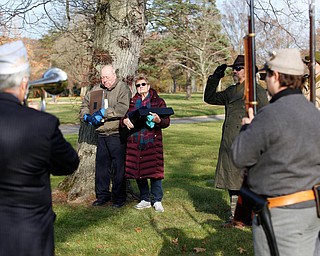 Suzanne Zadell, of Vermilion, stands with her husband Frank Zadell after she is presented with an American flag in honor of all she has done to learn more about her father, Raymond Eckert, who had been a sergeant with the 82nd Airborne Medical Division and died after his glider crashed on D-Day, during the Forgotten Heroes program in Forest Lawn Cemetery in Boardman on Sunday. EMILY MATTHEWS | THE VINDICATOR