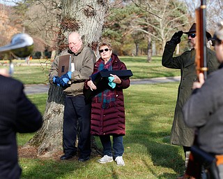 Suzanne Zadell, of Vermilion, stands with her husband Frank Zadell after she is presented with an American flag in honor of all she has done to learn more about her father, Raymond Eckert, who had been a sergeant with the 82nd Airborne Medical Division and died after his glider crashed on D-Day, during the Forgotten Heroes program in Forest Lawn Cemetery in Boardman on Sunday. EMILY MATTHEWS | THE VINDICATOR
