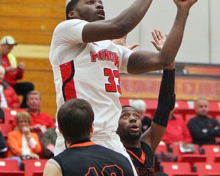 William D. Lewis The Vindicator YSU Naz Bohannon(33) shoots between Heildelberg's Jimmy Hanley(10) and Phaiz Watkins(5) during first half action 11-12-18 at YSU.