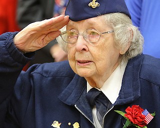 Veteran Donna Sheldon of Girard salutes as the Liberty High School choir sings the “Star Spangled Banner.” She attended the Veterans Day assembly Monday afternoon at Liberty High School.