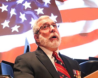 Roger Bacon, a Marine Corps veteran who served in the Vietnam War, addresses the Austintown Fitch High School auditorium filled with other veterans and students who paid them tribute during the school’s annual Veterans Day ceremony Monday.