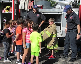 Neighbors | Jessica Harker.First-graders were allowed to try on fire fighter protective gear during their visit to the Boardman elementary schools on Oct. 10.