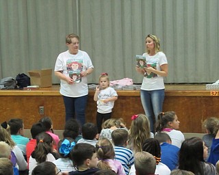 Neighbors | Jessica Harker.Diane and Laura Demetrios, along with Laura's daughter, read "Listen to Leslie" to second-graders at Poland Union Elementary School on Oct. 18.