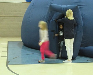 Neighbors | Jessica Harker.Groups of staff and students took turns watching the 30 minute show inside an inflatable planetarium on Oct. 25 at Poland Union Elementary School.
