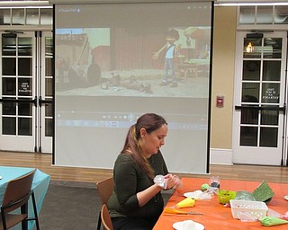 Neighbors | Jessica Harker.The movie "CoCo" played in the backround of the Dia de los Muertos, or Day of the Dead, celebration at the Poland library while librarian Annette Ahrens and others decorated sugar skulls.