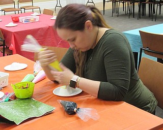 Neighbors | Jessica Harker.Librarian Annette Ahrens decorated a sugar skull on Nov. 1 at the Poland library's Dia de los Muertos event.