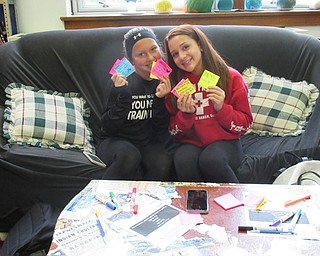 Neighbors | Jessica Harker.Students Ariel Grischob and Gabi Rondon, members of the Kindness Club, posed with their finished sticky notes.