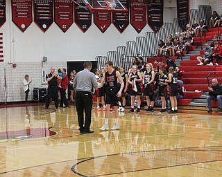Neighbors | Abby Slanker.Chase Lowry, a member of the Canfield High School boys basketball team, was met by boys varsity Head Coach Todd Muckleroy as he was introduced during the Meet the Team Rally on Nov. 8.