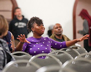 Brenda Scott, a relative of Valarica Blair and her 3-month-old son Tariq Morris, who were killed in a triple homicide last week, speaks about safety in the community during a community meeting at St. Dominic Church on Thursday night. EMILY MATTHEWS | THE VINDICATOR