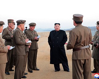 n this undated photo released Friday, Nov. 16, 2018, by the North Korean government, North Korean leader Kim Jong Un, center, listens to a military official as he inspects a weapon testing at the Academy of National Defense Science, North Korea. Kim observed the successful test of a "newly developed high-tech tactical" weapon, the nation's state media reported Friday, though it didn't describe what sort of weapon it was. Independent journalists were not given access to cover the event depicted in this image distributed by the North Korean government. The content of this image is as provided and cannot be independently verified. Korean language watermark on image as provided by source reads: "KCNA" which is the abbreviation for Korean Central News Agency.