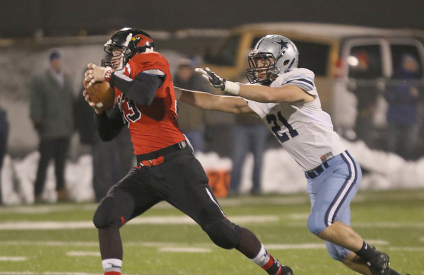             ROBERT  K. YOSAY | THE VINDICATOR..Canfield Cardinals lose in a Division III Region 9  final at Warren's Mollenkopf stadium ...Canfields Nick Crawford tries to elude #21 Kenston's Jake Englehart  as he goes for a first down during first half action